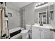 This bathroom has a shower over tub, updated vanity, and modern fixtures at 6520 Ouida Way, Las Vegas, NV 89108