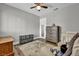 The large bedroom has a ceiling fan and furniture with ample natural light at 6520 Ouida Way, Las Vegas, NV 89108