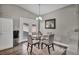 Bright dining room featuring a glass table, four chairs, and hardwood floors at 6520 Ouida Way, Las Vegas, NV 89108
