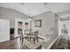 Bright dining room featuring a glass table, three chairs, and hardwood floors at 6520 Ouida Way, Las Vegas, NV 89108