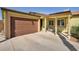 Lovely single-story home featuring a two-car garage and charming front porch with a comfortable chair at 6520 Ouida Way, Las Vegas, NV 89108