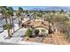 Charming home featuring mature palm trees, desert landscaping, and a two-car garage at 6520 Ouida Way, Las Vegas, NV 89108
