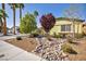Charming single-story home featuring desert landscaping, mature trees, and a well-maintained exterior at 6520 Ouida Way, Las Vegas, NV 89108
