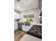 Bright kitchen features stainless appliances, white cabinets, quartz counters, laminate floors, and a farmhouse sink at 6520 Ouida Way, Las Vegas, NV 89108