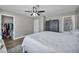 This is a spacious main bedroom with hardwood floors, ceiling fan, and walk-in closet at 6520 Ouida Way, Las Vegas, NV 89108