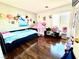 Bright bedroom with wood flooring, a window, and decor at 6819 Mahogany Meadows Ave, Las Vegas, NV 89122