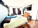 Spacious bedroom with hardwood flooring and large TV at 6819 Mahogany Meadows Ave, Las Vegas, NV 89122