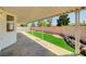 Covered patio with low-maintenance landscaped backyard and brick wall at 689 Hitchen Post Dr, Henderson, NV 89011