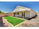 Home featuring an outdoor patio with covered area and faux grass at 689 Hitchen Post Dr, Henderson, NV 89011