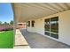 Back patio featuring covered area, sliding glass doors, and faux grass at 689 Hitchen Post Dr, Henderson, NV 89011