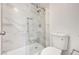 Bright bathroom featuring tiled shower with glass door and modern toilet at 689 Hitchen Post Dr, Henderson, NV 89011