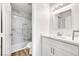 Bright bathroom with white quartz countertops, subway tile shower and new lighting fixtures at 689 Hitchen Post Dr, Henderson, NV 89011