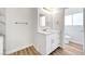 Bathroom with white vanity, marble countertop and tiled floors at 689 Hitchen Post Dr, Henderson, NV 89011