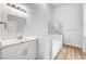 Bathroom with white vanity, marble countertop, separate tub and tiled shower at 689 Hitchen Post Dr, Henderson, NV 89011