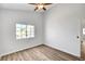 Bright bedroom with wood-look flooring and a view of the yard through the window at 689 Hitchen Post Dr, Henderson, NV 89011