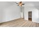 Spacious bedroom with wood-look floors, ceiling fan, walk in closet and neutral paint palette at 689 Hitchen Post Dr, Henderson, NV 89011