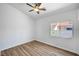 Bright bedroom with wood-look flooring and a ceiling fan and a window at 689 Hitchen Post Dr, Henderson, NV 89011