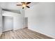 Bright bedroom with wood-look flooring, ceiling fan, and closet with clothing rod at 689 Hitchen Post Dr, Henderson, NV 89011