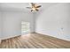 Bedroom with wood-look flooring and sliding glass doors to the backyard at 689 Hitchen Post Dr, Henderson, NV 89011