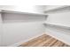Walk-in closet with wood-look floors, white walls and shelving at 689 Hitchen Post Dr, Henderson, NV 89011