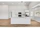 Bright kitchen features white cabinets, modern stainless appliances, and quartz countertop island at 689 Hitchen Post Dr, Henderson, NV 89011