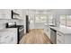 Open eat in kitchen showcasing stainless steel appliances, lots of windows, and a modern design at 689 Hitchen Post Dr, Henderson, NV 89011