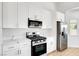 Modern eat in kitchen with stainless steel appliances, quartz countertops, and white cabinetry at 689 Hitchen Post Dr, Henderson, NV 89011