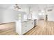 Spacious kitchen island with quartz countertops, stainless steel appliances, and wood flooring at 689 Hitchen Post Dr, Henderson, NV 89011