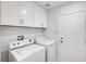 Laundry room features a washing machine and dryer with upper cabinets at 689 Hitchen Post Dr, Henderson, NV 89011