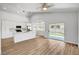 Open floor plan showcasing bright kitchen with stainless steel appliances and sliding glass door to backyard at 689 Hitchen Post Dr, Henderson, NV 89011