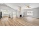 Spacious living room with wood floors, fireplace, and view into the kitchen at 689 Hitchen Post Dr, Henderson, NV 89011