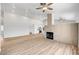 Open-concept living area featuring wood flooring, fireplace, and kitchen view at 689 Hitchen Post Dr, Henderson, NV 89011