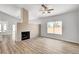 Bright living room featuring wood floors, fireplace, and large window at 689 Hitchen Post Dr, Henderson, NV 89011