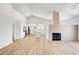 Open living space featuring high ceilings, wood floors, and a modern fireplace at 689 Hitchen Post Dr, Henderson, NV 89011