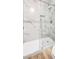 Modern bathroom features a glass-enclosed shower with marble-look tile surround at 689 Hitchen Post Dr, Henderson, NV 89011