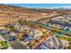 Aerial shot of a desert neighborhood with stylish homes, landscaping, and a pool at 6971 Cedar Basin Ave, Las Vegas, NV 89142