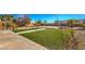 Expansive backyard featuring artificial turf, desert landscaping, and a concrete patio area at 6971 Cedar Basin Ave, Las Vegas, NV 89142