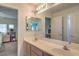 Well-lit bathroom featuring a double sink vanity with a large mirror and updated fixtures, providing ample space at 6971 Cedar Basin Ave, Las Vegas, NV 89142