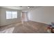 Spacious carpeted bedroom featuring a ceiling fan and lots of natural light from the window and sliding glass door at 6971 Cedar Basin Ave, Las Vegas, NV 89142