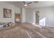 Spacious bedroom includes neutral carpet, ceiling fan, and doorway to bathroom at 6971 Cedar Basin Ave, Las Vegas, NV 89142