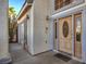 Welcoming front entrance featuring a decorative wooden door, sconce lighting, and inviting curb appeal at 6971 Cedar Basin Ave, Las Vegas, NV 89142