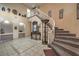 Elegant foyer featuring a staircase, decorative mirror, and tiled flooring, creating a grand entrance at 6971 Cedar Basin Ave, Las Vegas, NV 89142