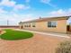 Backyard features artificial turf, low-maintenance desert landscaping, and a covered patio at 6982 Mirkwood Ave, Las Vegas, NV 89178