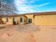 Backyard features a paved patio area, desert landscaping, and a view of the home's exterior at 6982 Mirkwood Ave, Las Vegas, NV 89178