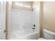 Clean bathroom features a shower-tub combo with white tiling and a modern showerhead at 6982 Mirkwood Ave, Las Vegas, NV 89178
