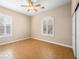 Cozy bedroom features wood floors, ceiling fan and shuttered windows at 6982 Mirkwood Ave, Las Vegas, NV 89178