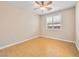 Bright, cozy bedroom features warm-toned walls, light-colored wood-look flooring, and plantation shutters for privacy at 6982 Mirkwood Ave, Las Vegas, NV 89178