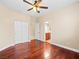 Comfortable bedroom with wood-look floors, ceiling fan and a convenient ensuite bathroom access at 6982 Mirkwood Ave, Las Vegas, NV 89178