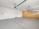 Clean garage with epoxy flooring, built-in storage cabinets, and high ceilings at 6982 Mirkwood Ave, Las Vegas, NV 89178
