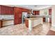 Modern kitchen with granite countertops, stainless steel appliances, large island, and ample cabinet space at 6982 Mirkwood Ave, Las Vegas, NV 89178